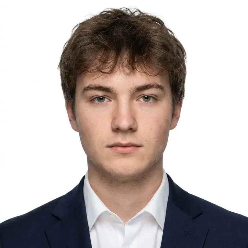 ChatGPT passport photo prompt result: dark suit jacket and white shirt added, plain white background